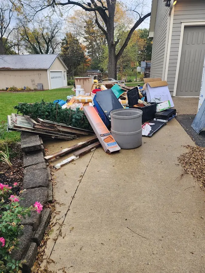 Dumpster being loaded with debris for Estate Cleanout Dumpster Rental in McCall